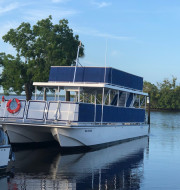 Blue and white pontoon boat docked in the water